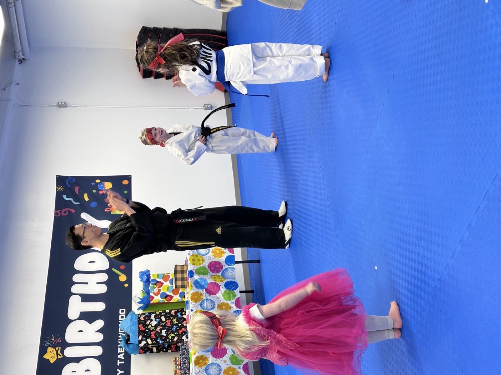 Master Nam leading children in games at a Unity Taekwondo birthday party in Chilliwack